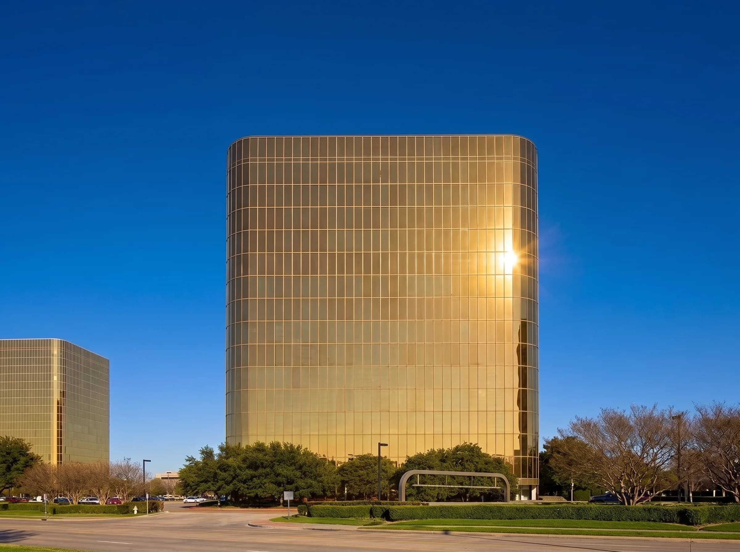 Golden glass tower under a deep blue sky