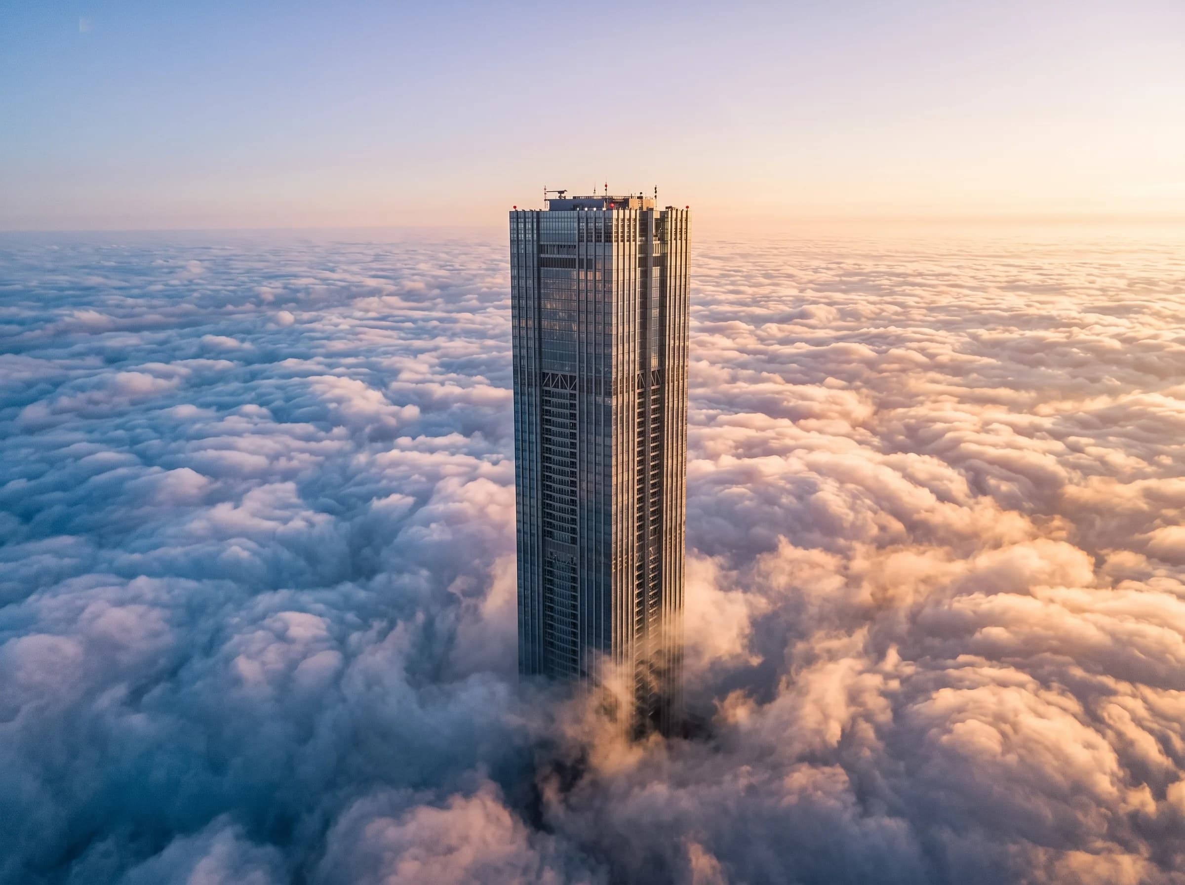Tower rising above a sea of clouds at sunrise