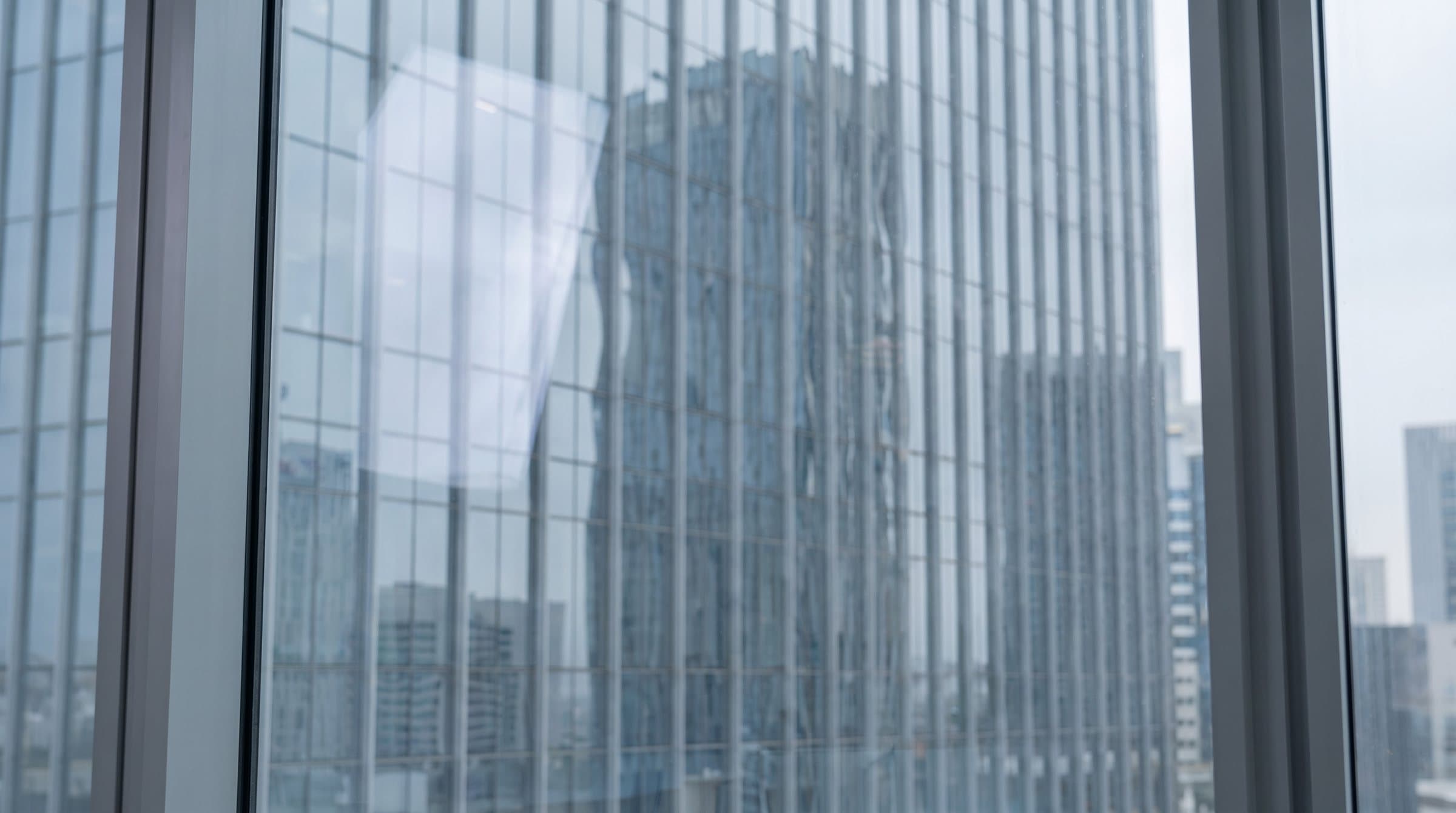 Glass façade reflecting the city